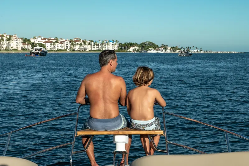 Slide: The Image of Father and son on Hanover 375 yacht, enjoying ocean view, 2026. - 89