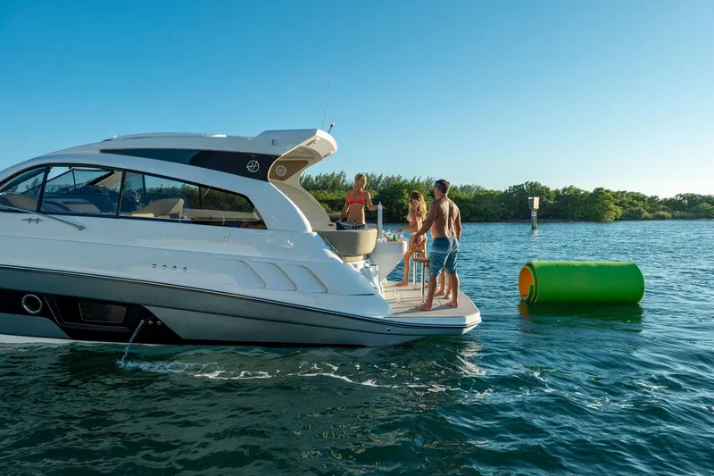 Slide: The Image of Luxury Hanover 375 yacht, 2026 model, with people enjoying a sunny day on the water. - 91