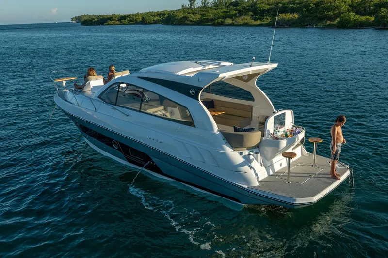 Slide: The Image of 2026 Hanover 375 yacht on serene water, featuring passengers enjoying leisure activities. - 99