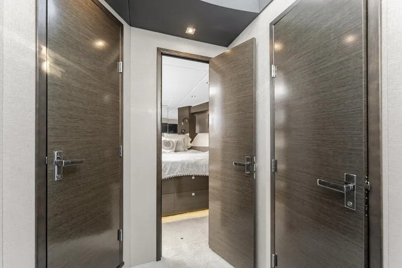 Slide: The Image of Interior of 2018 Cruisers Yachts 50 Cantius, featuring modern doors and luxurious bedroom. - 27