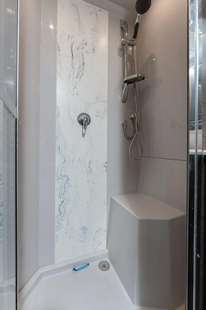 Slide: The Image of Shower area in 2018 Cruisers Yachts 50 Cantius with modern fixtures and seating. - 11