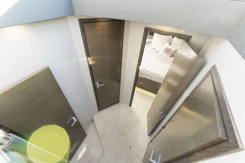 Slide: The Image of Interior view of 2018 Cruisers Yachts 50 Cantius, featuring modern doors and a cozy bedroom. - 30