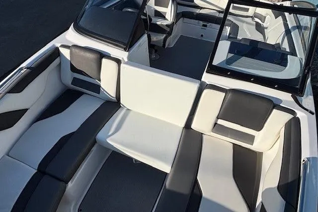 Slide: The Image of 2021 Yamaha Boats AR210 interior with sleek, modern seating and open cockpit design. - 10