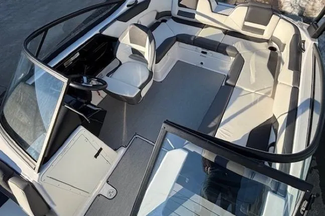 Slide: The Image of 2021 Yamaha Boats AR210 interior with spacious seating and modern design. - 11