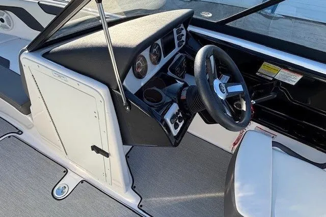 Slide: The Image of 2021 Yamaha Boats AR210 cockpit with steering wheel and dashboard controls. - 16