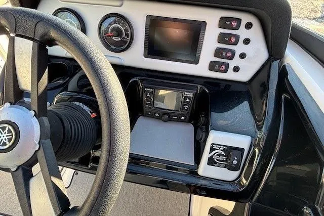 Slide: The Image of 2021 Yamaha AR210 boat dashboard with steering wheel and control panel. - 18
