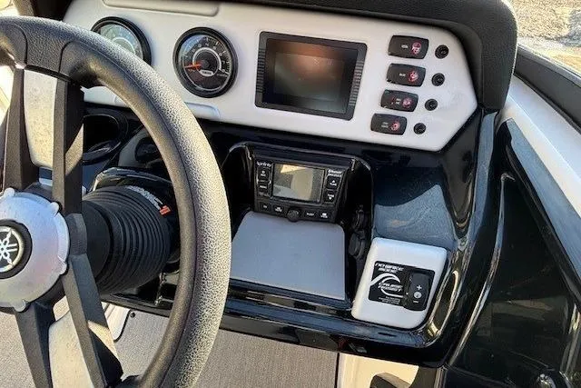Slide: The Image of Dashboard of a 2021 Yamaha Boats AR210, featuring steering wheel and control panel. - 19