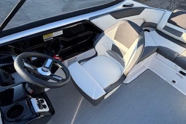 Slide: The Image of 2021 Yamaha Boats AR210 interior with steering wheel and seating area. - 20