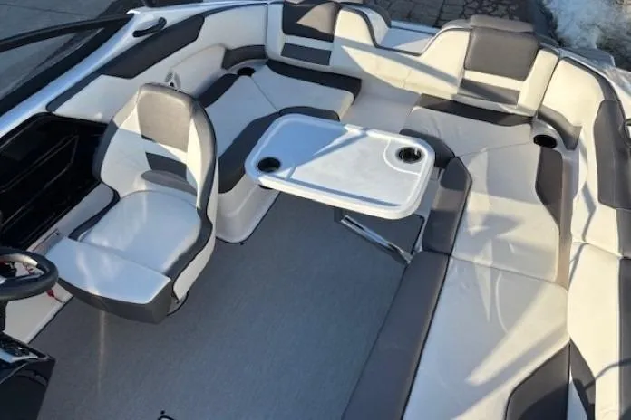 Slide: The Image of 2021 Yamaha Boats AR210 interior with seating and table, featuring modern design and comfort. - 23