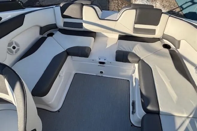 Slide: The Image of 2021 Yamaha Boats AR210 interior with spacious seating and modern design. - 25