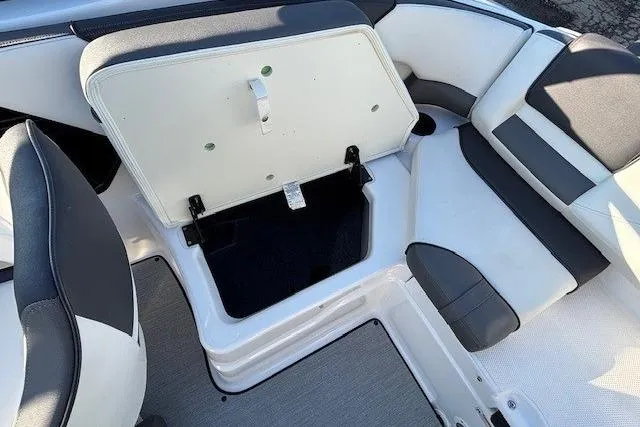 Slide: The Image of 2021 Yamaha AR210 boat interior with open storage compartment and cushioned seating. - 26