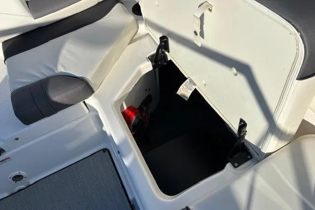 Slide: The Image of Open storage compartment in 2021 Yamaha AR210 boat interior. - 27