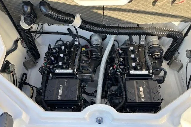 Slide: The Image of 2021 Yamaha AR210 boat engine compartment with dual engines and wiring. - 28