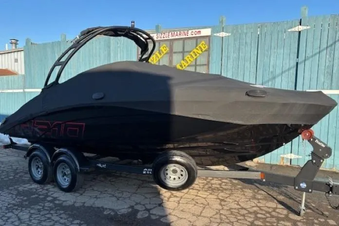 Slide: The Image of 2021 Yamaha AR210 boat covered on trailer, parked outdoors. - 32