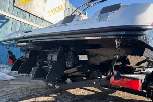 Slide: The Image of 2021 Yamaha Boats AR210, rear view showing dual engines and trailer, parked outdoors. - 4