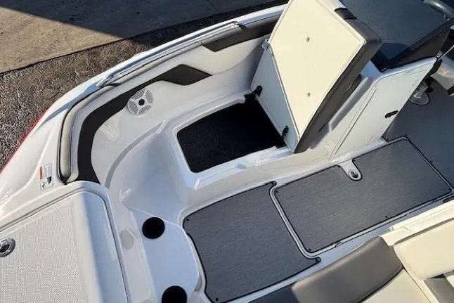Slide: The Image of 2021 Yamaha AR210 boat interior with open storage compartment and seating area. - 8