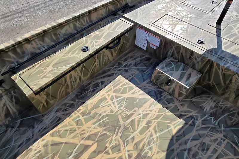 Slide: The Image of 2026 Lowe Roughneck RX2070 SC boat interior with camouflage design and storage compartments. - 5