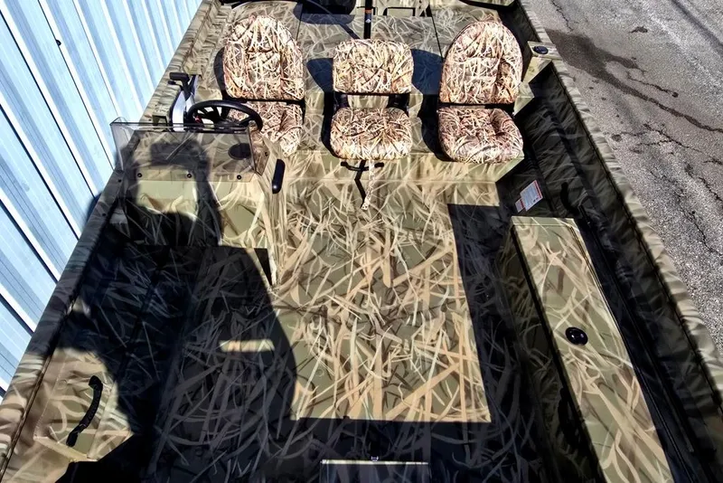 Slide: The Image of 2026 Lowe Roughneck RX2070 SC boat with camouflage seats and steering console. - 7