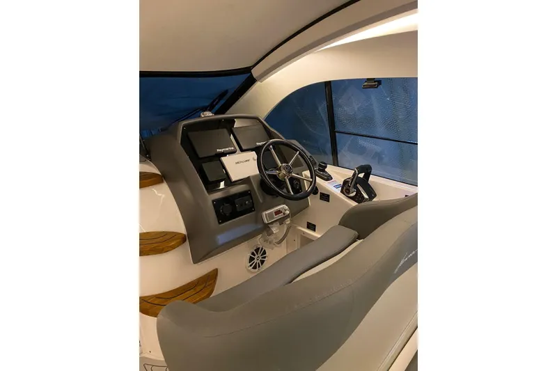 Slide: The Image of Interior view of 2026 Hanover 375 boat cockpit with steering wheel and controls. - 12