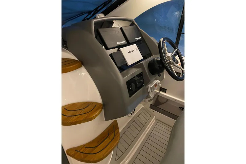 Slide: The Image of Interior of 2026 Hanover 375 boat with modern dashboard and steering wheel. - 14