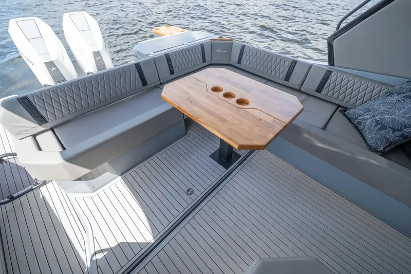Slide: The Image of Luxurious seating area on 2026 Hanover 387 boat with wooden table and quilted cushions. - 15