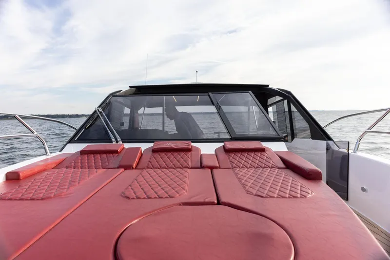 Slide: The Image of Luxury Hanover 387 yacht with red leather seating, cruising on open water, 2026 model. - 10