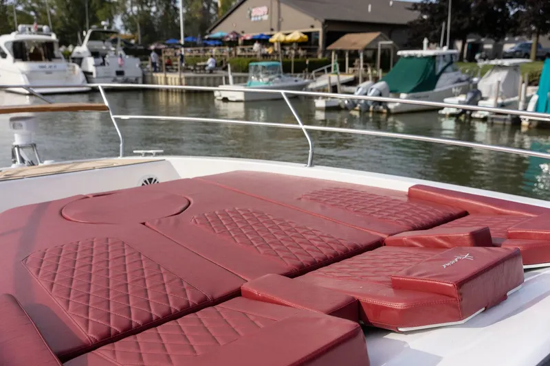 Slide: The Image of Luxury Hanover 387 yacht with red cushioned deck, docked at marina, 2026 model. - 11