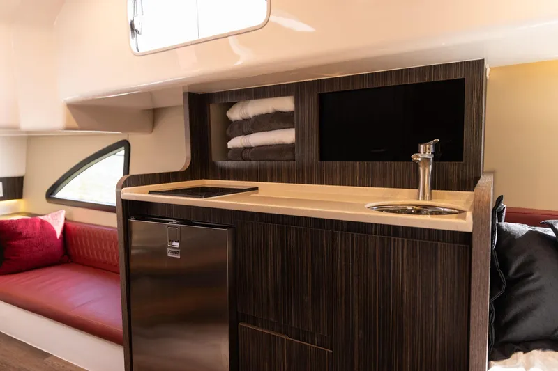 Slide: The Image of Luxurious interior of 2026 Hanover 387 yacht with kitchenette and seating area. - 14