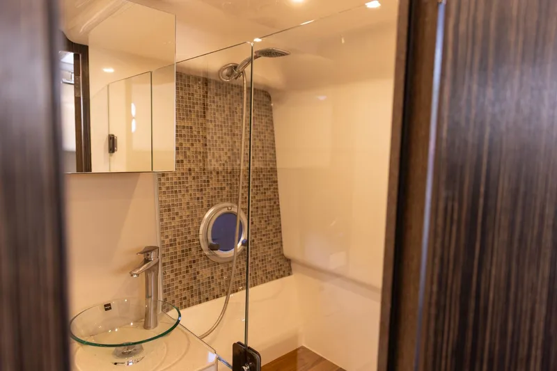 Slide: The Image of Modern bathroom in 2026 Hanover 387 with glass sink and mosaic tiles. - 19