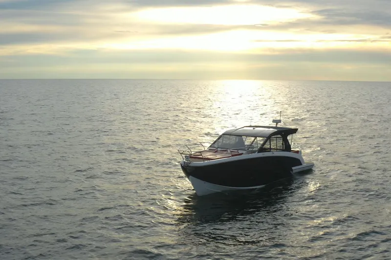 Slide: The Image of Luxury Hanover 387 boat on serene ocean at sunset, 2026 model. - 4