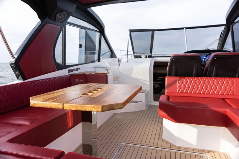 Slide: The Image of Luxurious 2026 Hanover 387 yacht interior with red seating and wooden table. - 7