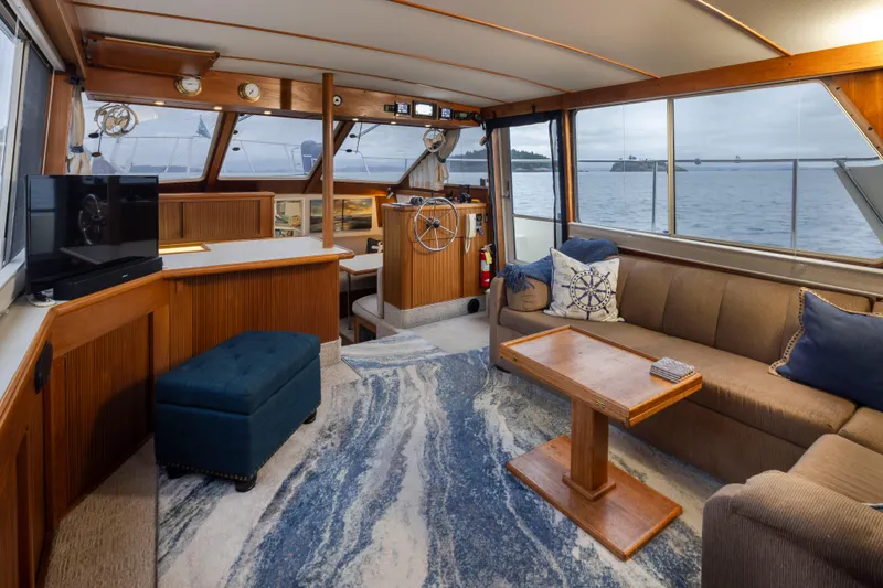 Slide: The Image of Luxurious interior of a 1990 Tollycraft 44 Cockpit Motor Yacht with elegant seating and ocean view. - 12