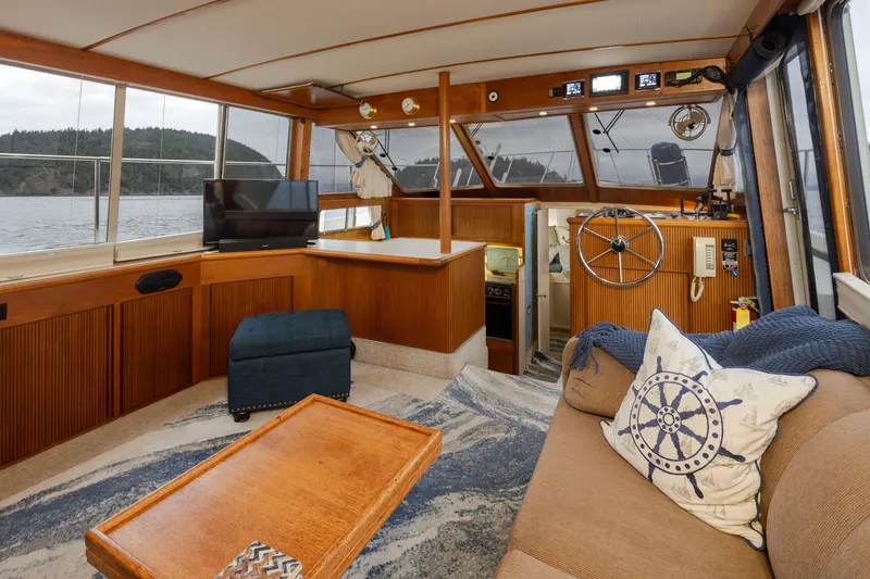 Slide: The Image of Interior of 1990 Tollycraft 44 Cockpit Motor Yacht with cozy seating and helm. - 13