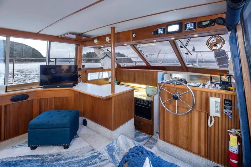 Slide: The Image of Interior of 1990 Tollycraft 44 Cockpit Motor Yacht with helm, TV, and seating area. - 14