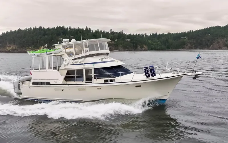 Slide: The Image of 1990 Tollycraft 44 Cockpit Motor Yacht cruising on a scenic waterway. - 2