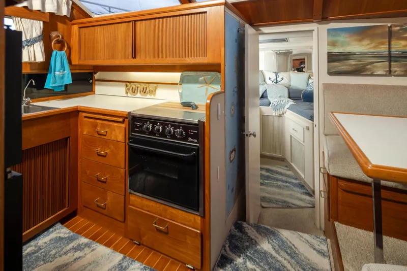 Slide: The Image of 1990 Tollycraft 44 Cockpit Motor Yacht interior with kitchen and cozy cabin. - 20