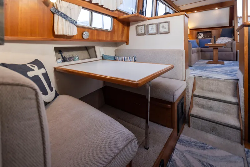 Slide: The Image of Interior of 1990 Tollycraft 44 Cockpit Motor Yacht with cozy dining area and nautical decor. - 21
