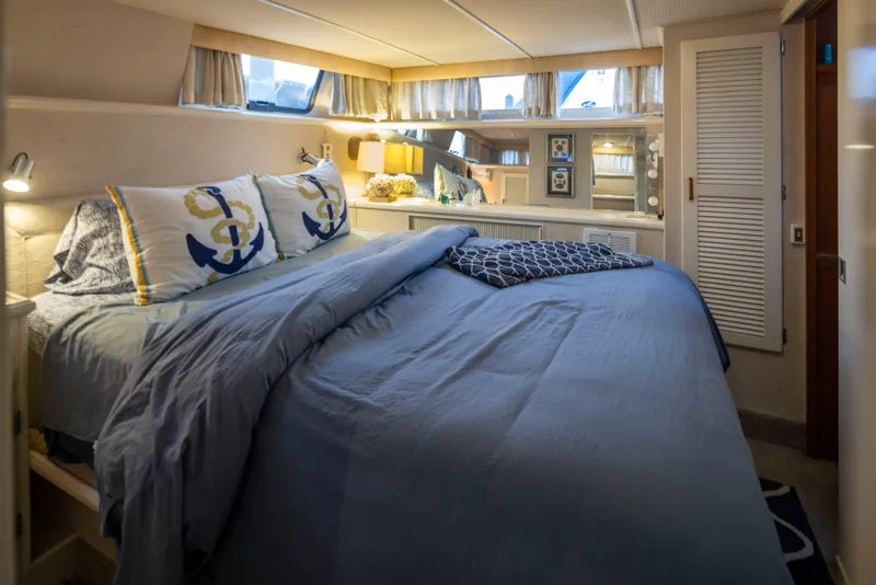 Slide: The Image of Cozy bedroom in 1990 Tollycraft 44 Cockpit Motor Yacht with nautical-themed decor. - 24