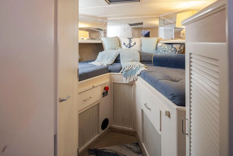 Slide: The Image of Interior of 1990 Tollycraft 44 Cockpit Motor Yacht with cozy bedding and nautical decor. - 27