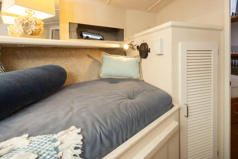 Slide: The Image of Cozy cabin interior of 1990 Tollycraft 44 Cockpit Motor Yacht with plush bedding. - 29