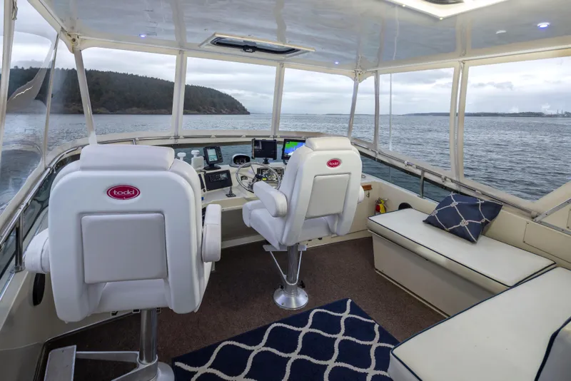 Slide: The Image of Interior of 1990 Tollycraft 44 Cockpit Motor Yacht with helm and seating area. - 32