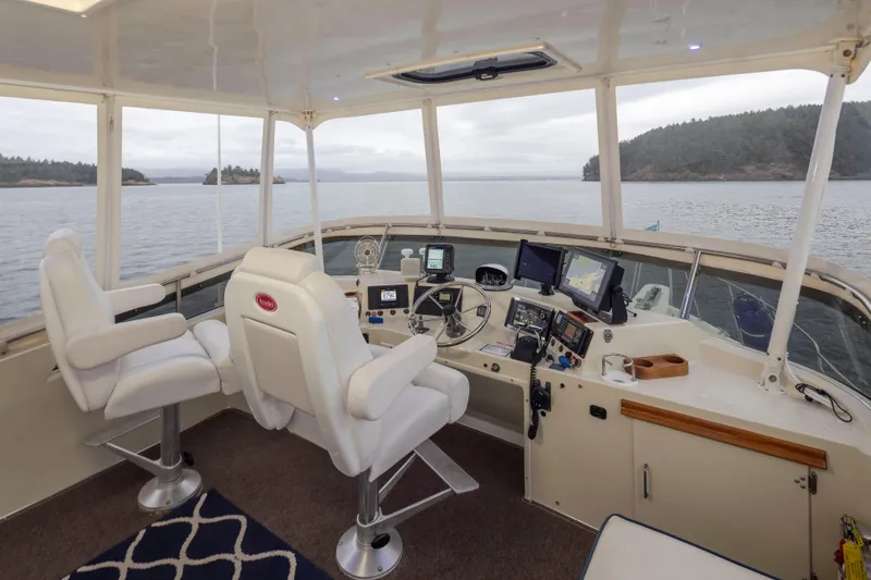 Slide: The Image of Interior of 1990 Tollycraft 44 Cockpit Motor Yacht with navigation equipment and scenic water view. - 33