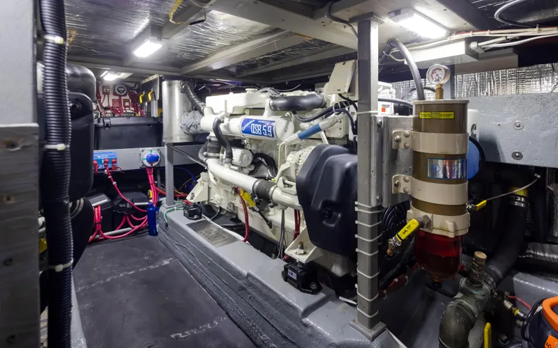 Slide: The Image of Engine room of 1990 Tollycraft 44 Cockpit Motor Yacht, showcasing mechanical components and wiring. - 35