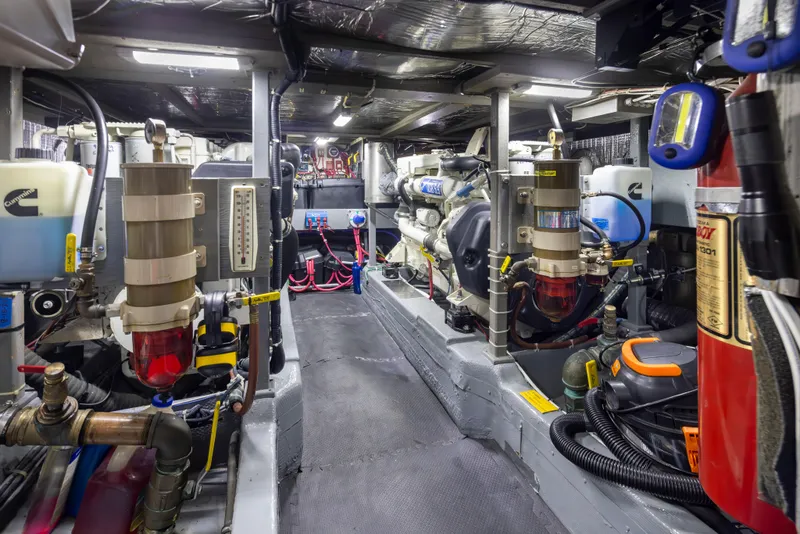 Slide: The Image of Engine room of 1990 Tollycraft 44 Cockpit Motor Yacht, featuring mechanical components and equipment. - 36