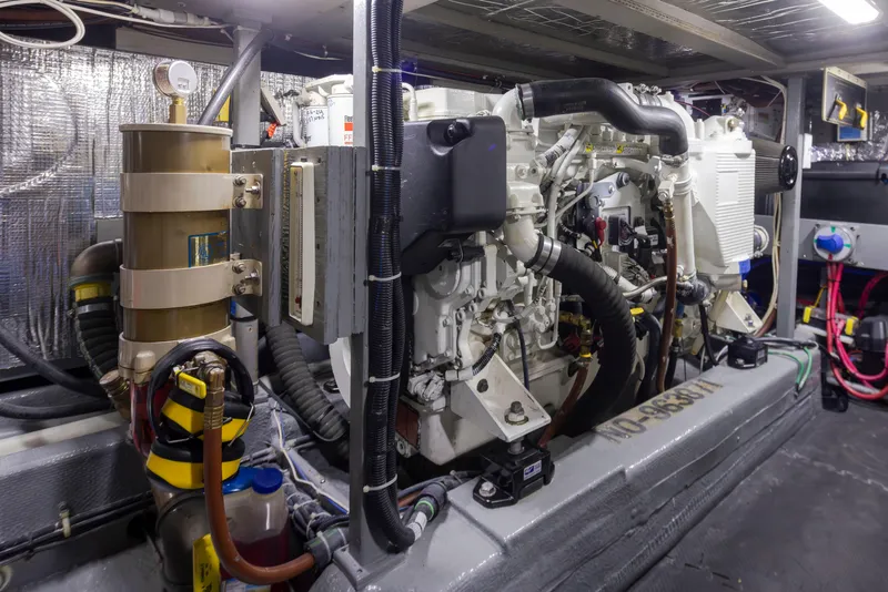 Slide: The Image of Engine room of a 1990 Tollycraft 44 Cockpit Motor Yacht, showcasing detailed machinery. - 37