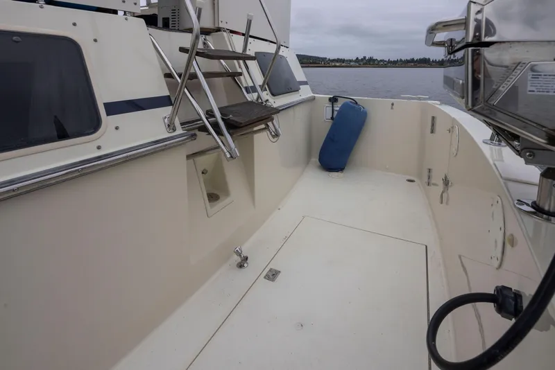 Slide: The Image of 1990 Tollycraft 44 Cockpit Motor Yacht deck with ladder and blue fender. - 41