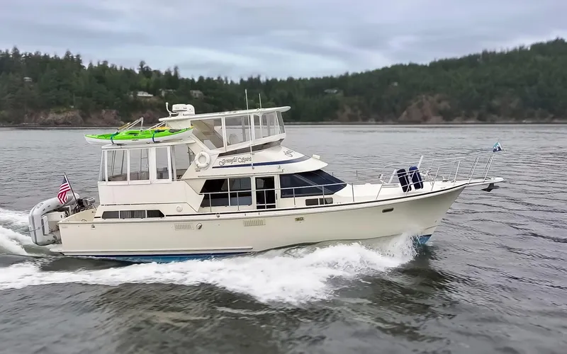 Slide: The Image of 1990 Tollycraft 44 Cockpit Motor Yacht cruising on a scenic waterway. - 5