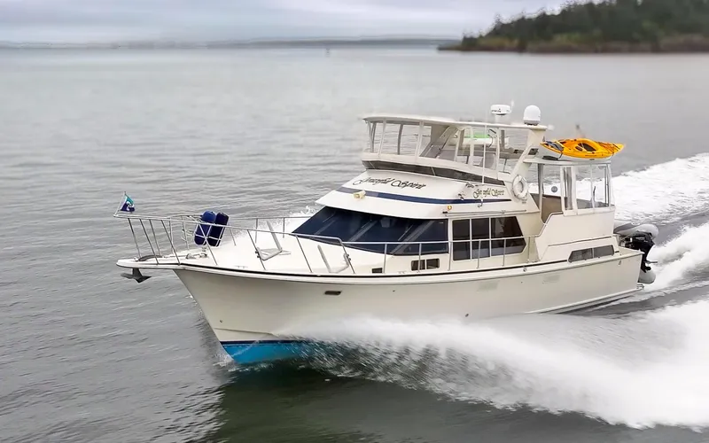 Slide: The Image of 1990 Tollycraft 44 Cockpit Motor Yacht cruising on open water. - 7