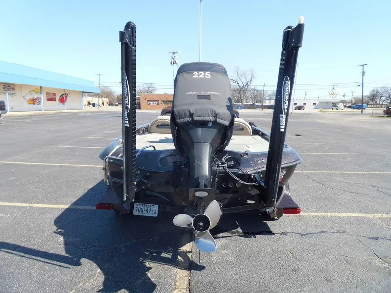 Slide: The Image of 2000 Ranger 520DVX Comanche with outboard motor in parking lot. - 11
