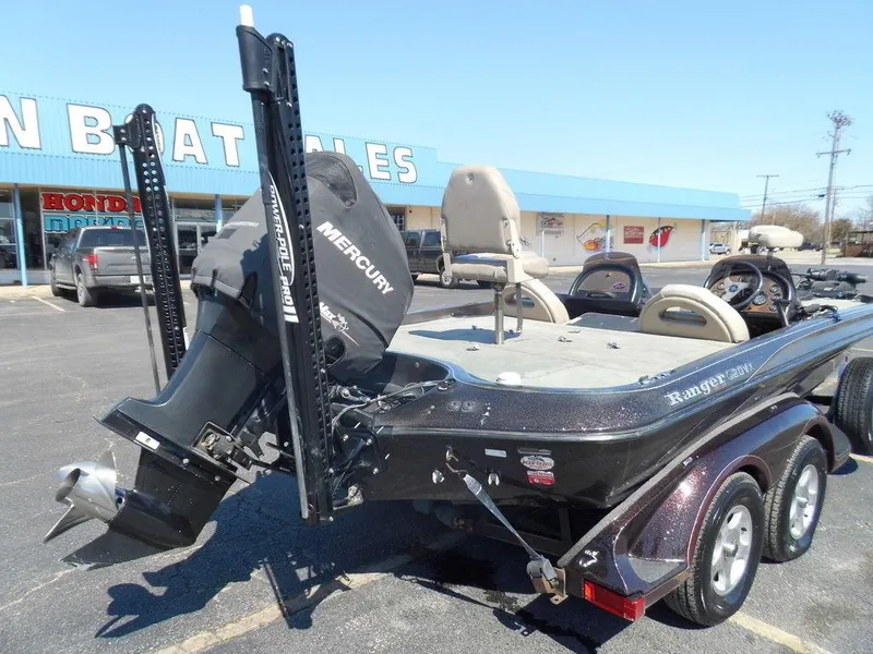 Slide: The Image of 2000 Ranger 520DVX Comanche with Mercury engine on parking lot. - 12